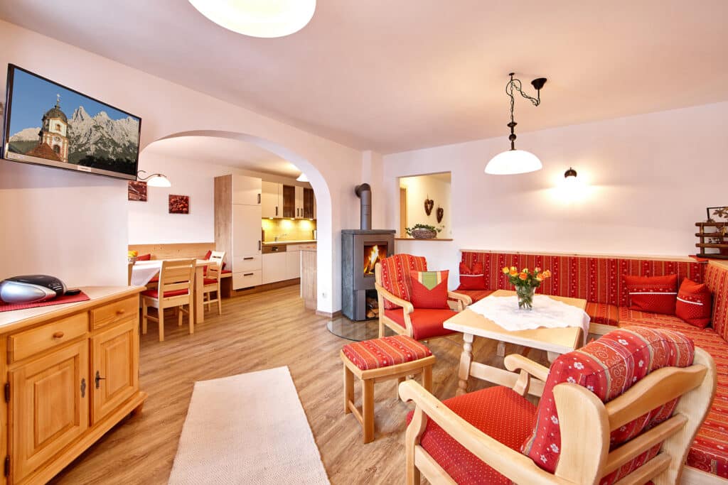 1_Wohnzimmer mit gemütlicher Couch, Fernseher und Kamin